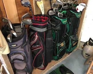 Golf bags, golf clubs, T box and putters caddie