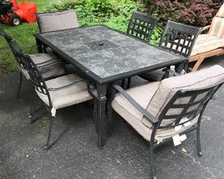 Slate top patio table with six matching chairs