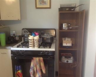 Pots and pans, waffle iron, cabinet, gas stove
