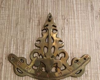 Wall hanging of a sextant in brass