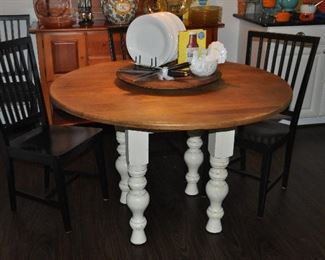 48” round wooden Kitchen Table from Hudson Dry Goods, NYC with ivory Shabby Chic wooden legs shown with a set of 4 black painted wood dining chairs from Crate and Barrel