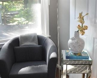 Lovely sitting area includes an Ikea grey Barrel Chair and one of the two petite mirrored side tables