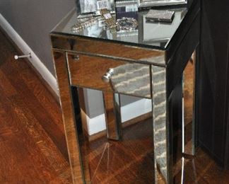 Up close view of the petite mirrored side table, each are 14”w x 25.5”h x 14”d