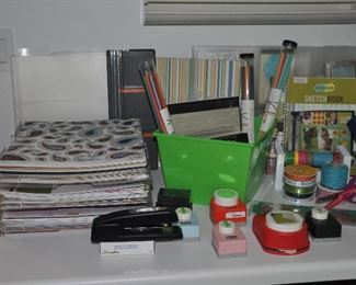 Unbelievable collection of scrapbooking supplies, including McGill paper cutters, kits for different subjects, ribbon and Fisker paper trimmers.