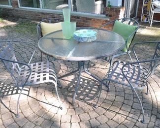 Iron outdoor wrought iron/ glass dining table and chair set. Table measures 41” x 28”