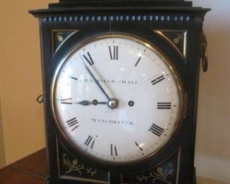 An  inlaid bracket clock, 19th century, the dial signed Hatfield and Hall Manchester, with side grilles and ring handles.