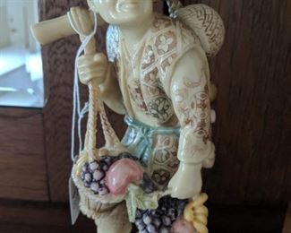 Oxbone netsuke carved man carrying fruit