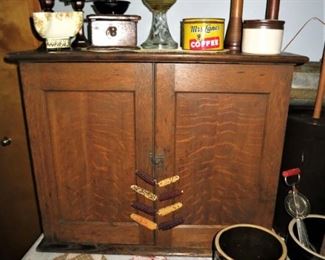Antique cupboard, coffee grinder, kerosene lamp, wooden spools, coffee tin, misc. crocks/jugs, metal hat/tie hangers, corn cob display, etc.
