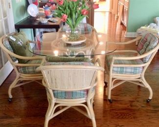 Another view of the Rattan/Glass Dining Table w/4 Rolling Chairs