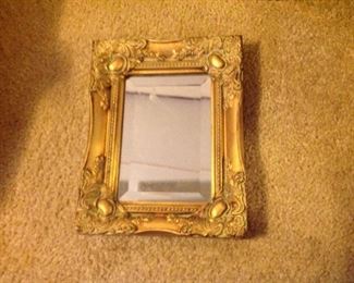 Small, framed beveled mirror---about 8" by 6"