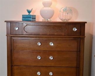 Tall dresser with glass knobs.