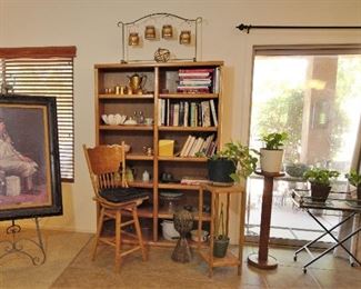 Bookcase and lots of decorative household items and small tables along with great art.