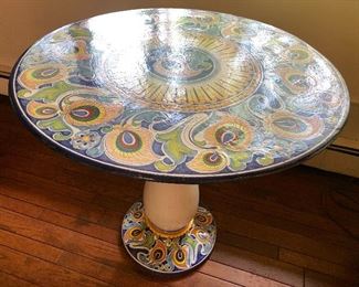 Set of handpainted volcanic stone table tops on handpainted stone pedestals. One table is in a geometric pattern and this one is in the classic majolica pattern. Each Table is 32" in diameter and 29" tall.