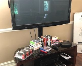 50" Panasonic TV - Plasma, PS2 games, XBox games and DVDs and TV stand with shelves below 