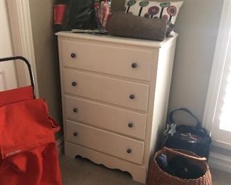Dresser, knitting needles and yarn, basket, pillow, and carry cart