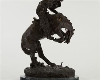 After Frederick Remington (1861-1909). Bronze equestrian sculpture titled "Rattlesnake," depicting a rider clinging to a horse that rears to avoid a rattlesnake. Signed "Copyright Frederic Remington" in the bronze above the marble base. 
SKU: 01802
Follow us on Instagram: @revereauctions