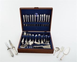 Set of sterling silver flatware marked "Treasure Sterling, Pat. Nov. 12 '18." Set is comprised of twelve dinner knives, twelve butter knives, one carving fork, one carving knife, one spatula, fifteen dinner forks, twelve salad forks, twelve dessert forks, twenty two tablespoons, thirteen pronged spoons, twelve dessert spoons, twelve spreader knives, seven three pronged forks, six teaspoons, one pair of tongs, one strainer, three specialty spoons, two specialty forms, three soup spoons, and one serving fork. 
SKU: 01844
Follow us on Instagram: @revereauctions