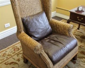 Wicker wing chair with leather upholstered cushions $240
