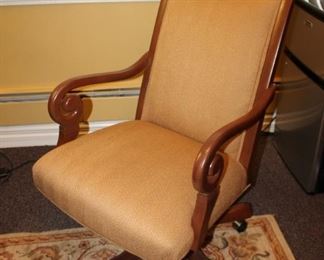 Rolling wood desk chair with scroll arms, fabric upholstery $160