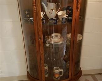 Beautiful antique curio cabinet filled with dishes from Romania