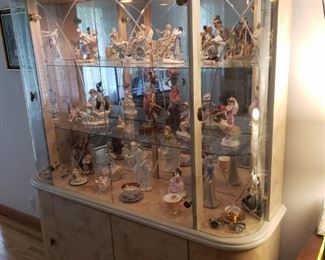 Curio cabinet/china cabinet filled with antique collectible figurines and dishes