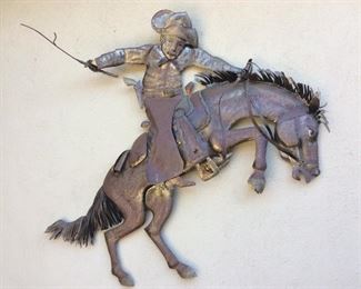 Commissioned brass horse and cowboy, very large piece, is hanging outside and has nice patina