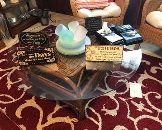 glass-top coffee table with bamboo-rattan base