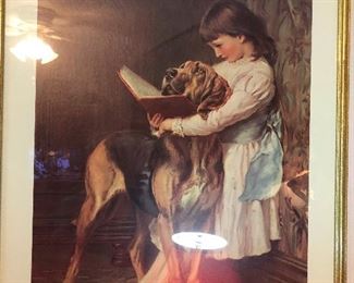girl is teaching dog to read