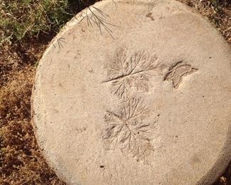 Close-up of artist made garden stepping stone impressed lead and butterfly