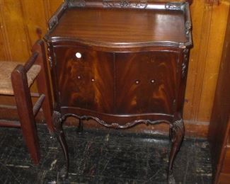 bow front flame mahogany nightstand with carved gallery and legs
