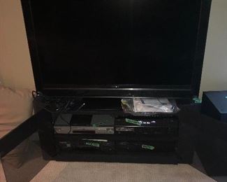 46” Sony Bravia HDTV and DVD player, DVD player, subwoofer, receiver, and glass-door TV stand. Surround sound ready!
