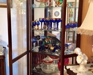 Display case with stemware and Murano glass