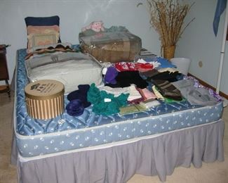 Bed, some bedding, clothing