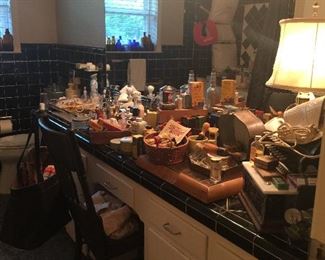 Looking into the bathroom, lots of vintage items, a great collection of shaving items including a display. Lots of perfume bottles, perfume, soaps, lotions and appliances 