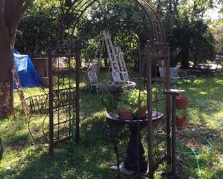 Metal trellis, bird baths, planters, plants