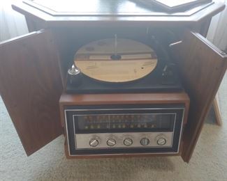Magnavox AM/FM Stereo and turntable.  Everything works!  Enclosed in a drum side table/cabinet.