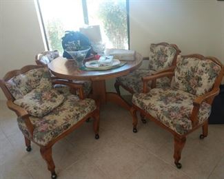 Cutest little round oak table with four great arm chairs on wheels!