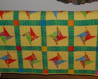 A number of nice quilts and quilted table covers.
