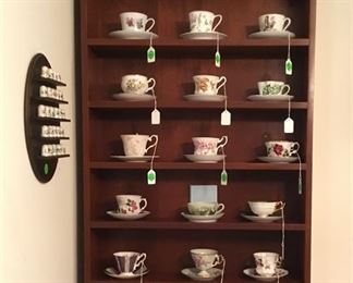 Cup holder with collectible cups and saucers.