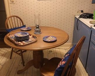 Oak pedestal table. Two Windsor chairs.