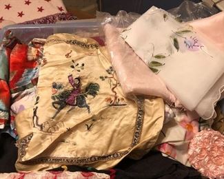 Box full of old linens, pillow covers, dresser scarves