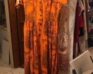 Clothes rack full of vintage dresses, coats, skirts, aprons