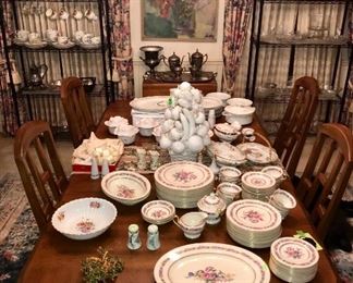 Dining room table staged with gorgeous china sets