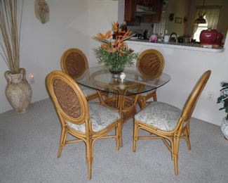 Very nice dinette set. Glass top, Cane base, 4 chairs