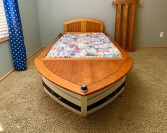 Twin trundle pottery barn boat bed. Extra storage in the front of the boat bed 