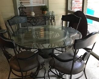 Glass top patio table with upholstered chairs