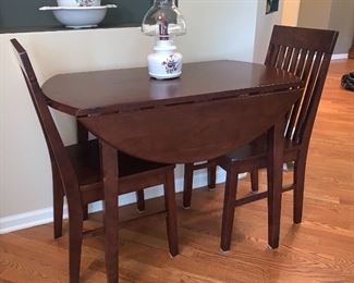  Kitchen table with two fold/drop leaf sides and two chairs. Perfect for those small kitchens or Dining Rooms