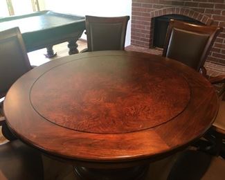 Beautiful 54" Braddock Poker Game Table, distressed cherry color, with 6 pleather chairs that rock, swivel, and even have adjustable height!! Table has pull out storage drawers for coasters, cards, etc., and base has storage as well. Complete set at NFM was $2500.00 Our price is a real bargain! Asking $800 OBO Features
Lightly distressed finish in Hampton Cherry on select hardwoods and veneers
This pub and amp game table has durable clear coat for wear protection
Accommodates 6 people and features six full-extension drawers. Each drawer holds beverages and snacks and includes a removable sandstone drink coaster to absorb moisture
The reversible removable top features rare olive ash burl veneers on the dining surface side and a fabric poker-playing surface on the other
The storage base features four framed panels with rare olive ash burl veneers which complement the tabletop
A hinged door offers access to convenient storage in the base for accessories. Storage area includes a fixed shel