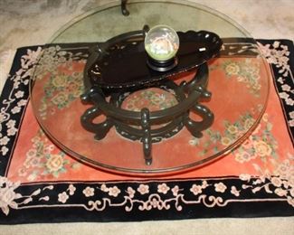 Oriental plush rug and glass top sofa table.  