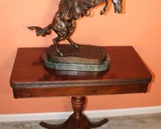 Frederick Remington, Bronco Buster shown on a game table.  